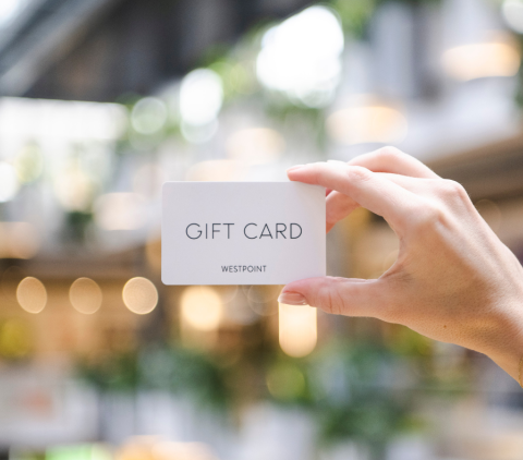 A woman holding up a Gift Card in Westpoint