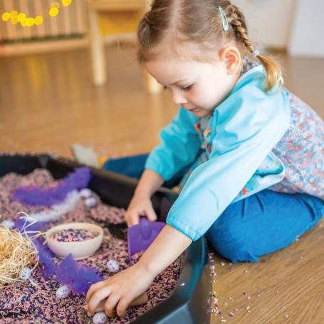 little girl playing in sand