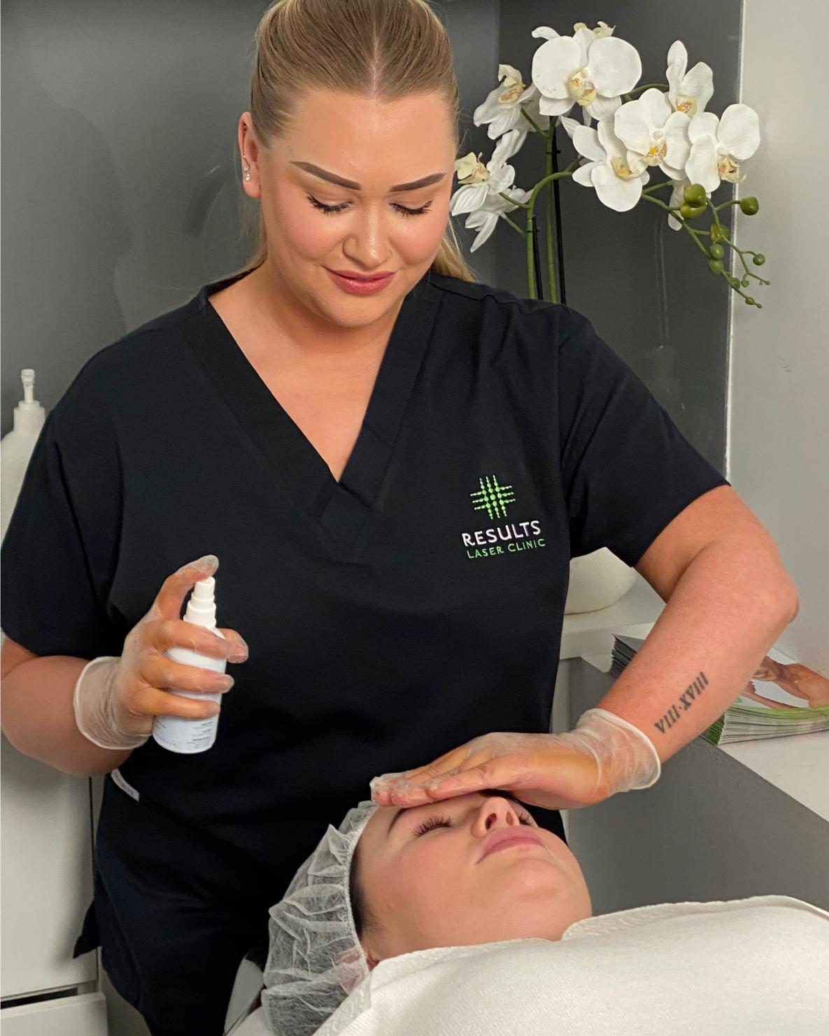 A woman is getting a beaty treatment done by an employee at Results Laser Clinic.